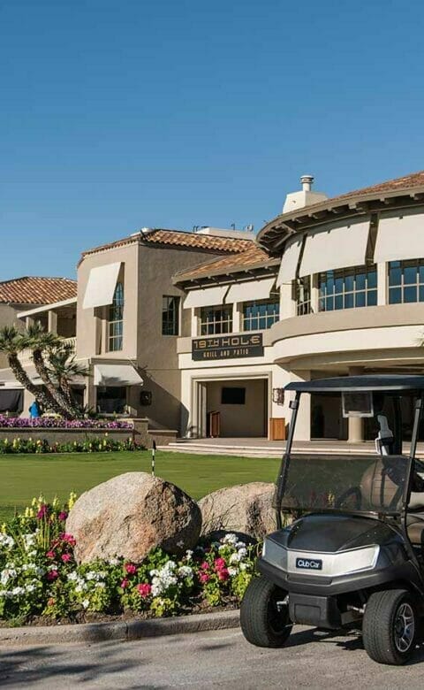 two golf carts parked out front of 19th Hole Restaurant