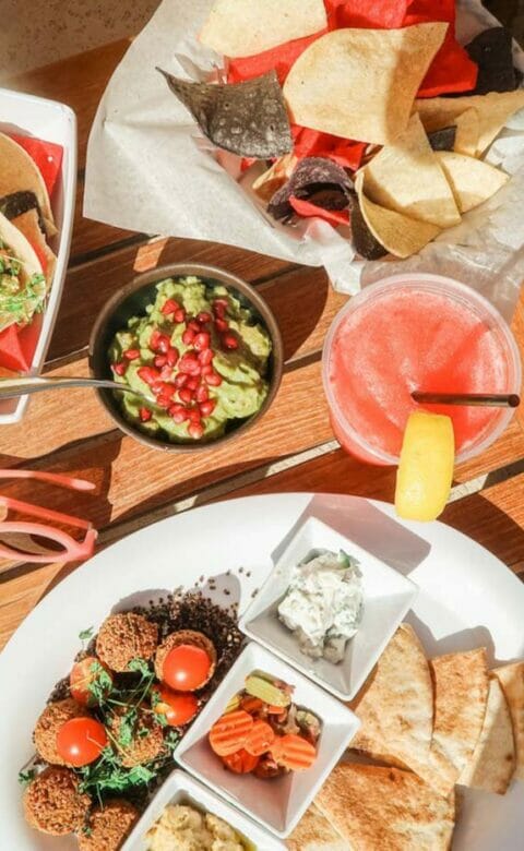 top down view of food plates featuring tacos and chips