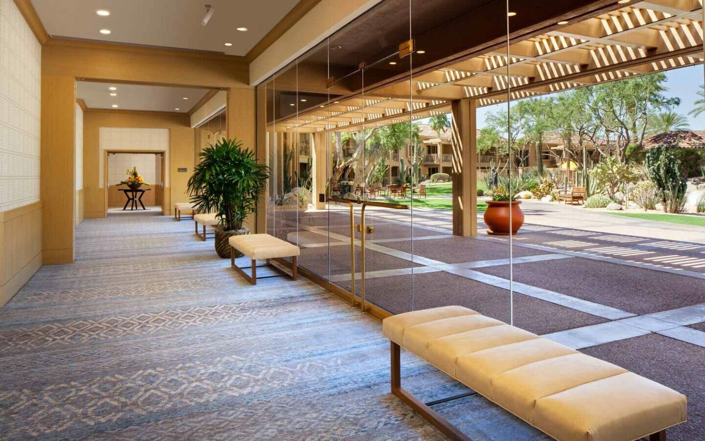 resort conference lobby with glass doors and benches with white cushions