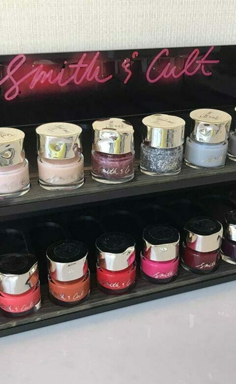 two rows of Smith & Cult nail products displayed on a shelf