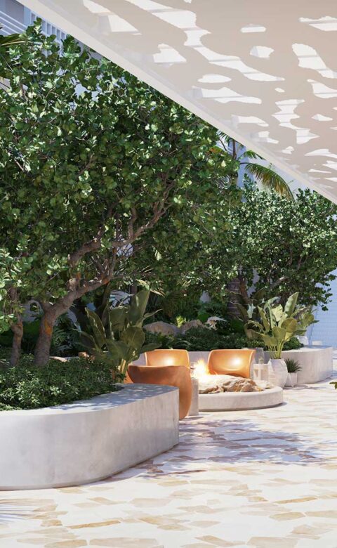 Tropical garden walkway with fire pit lounge and modern seating at Royal Palm South Beach