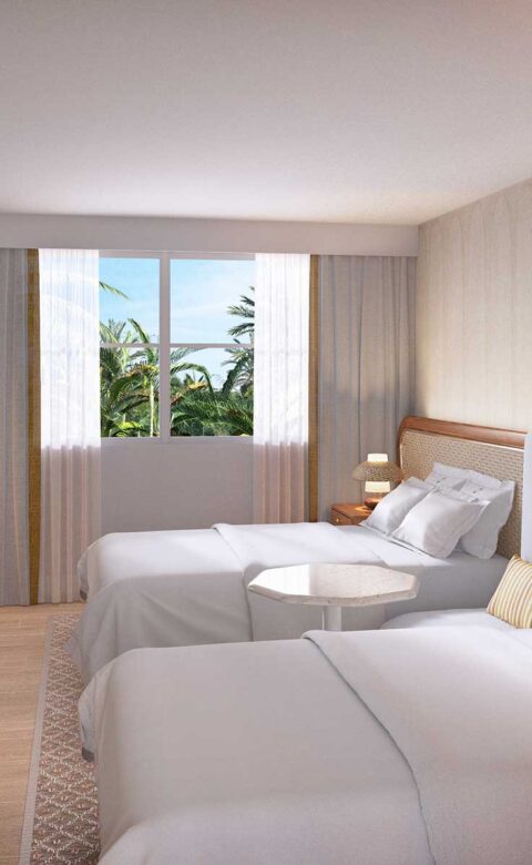 Double queen hotel room with natural wood accents and tropical garden view