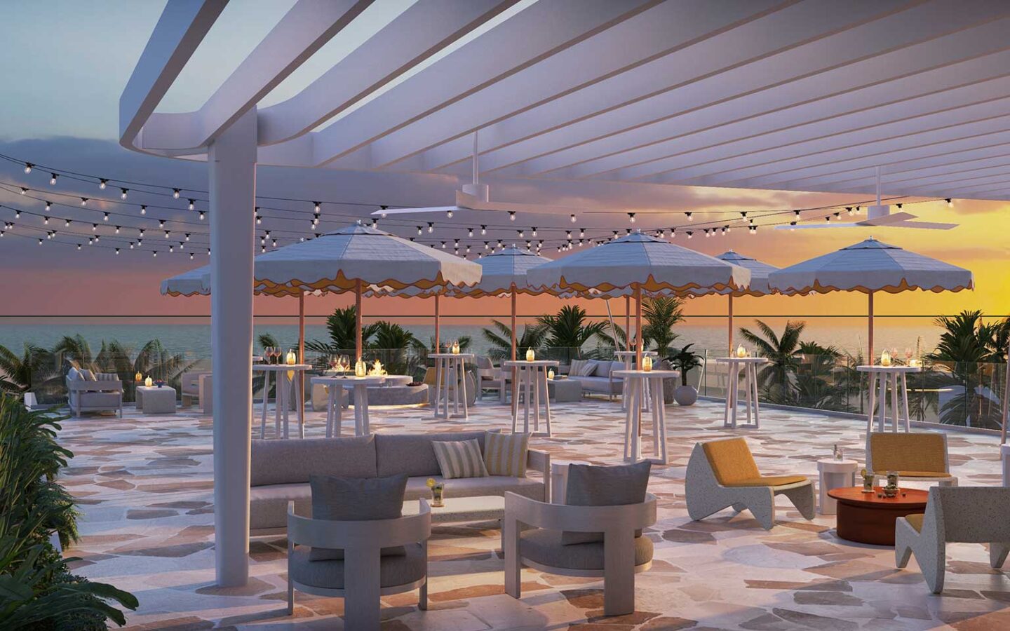 Rooftop terrace at sunset with ocean views, string lights, and umbrella-covered seating.